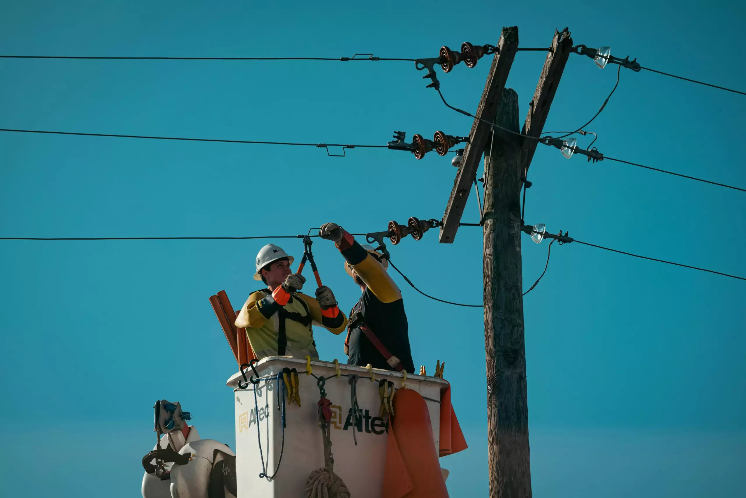 electrical engineers fixing the electric lines using an aerial platform lift