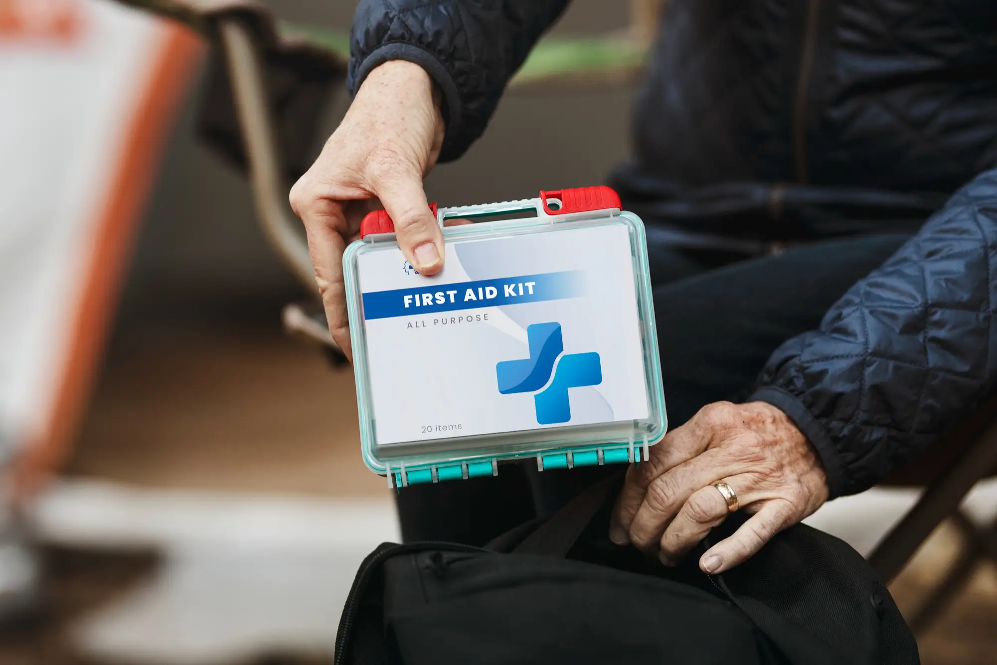 A worker is showing his first aid kit for unwanted emergencies in workplace