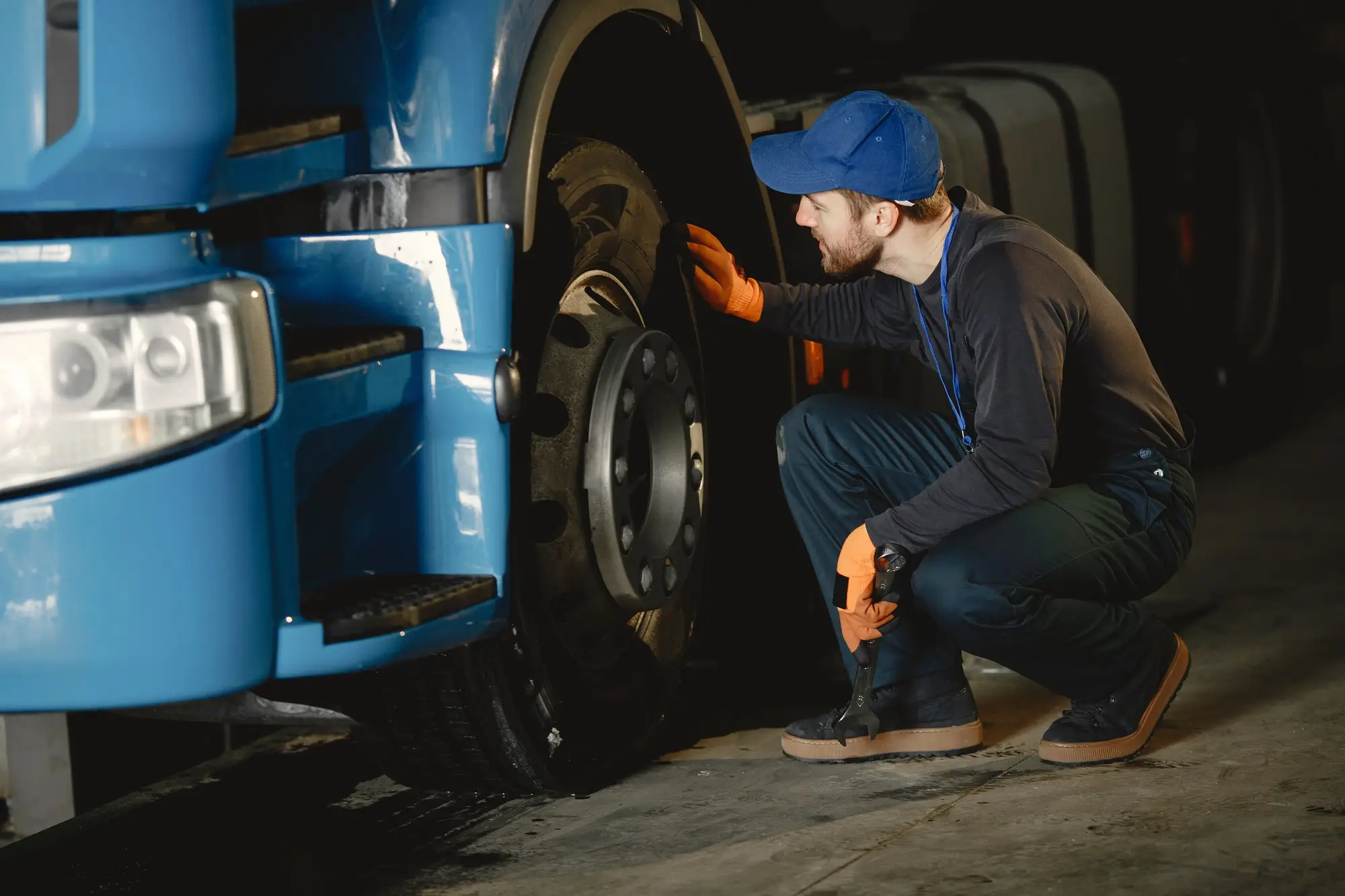 A young driver inspecting his truck's wheel. A Pre-trip inspection of his Truck 