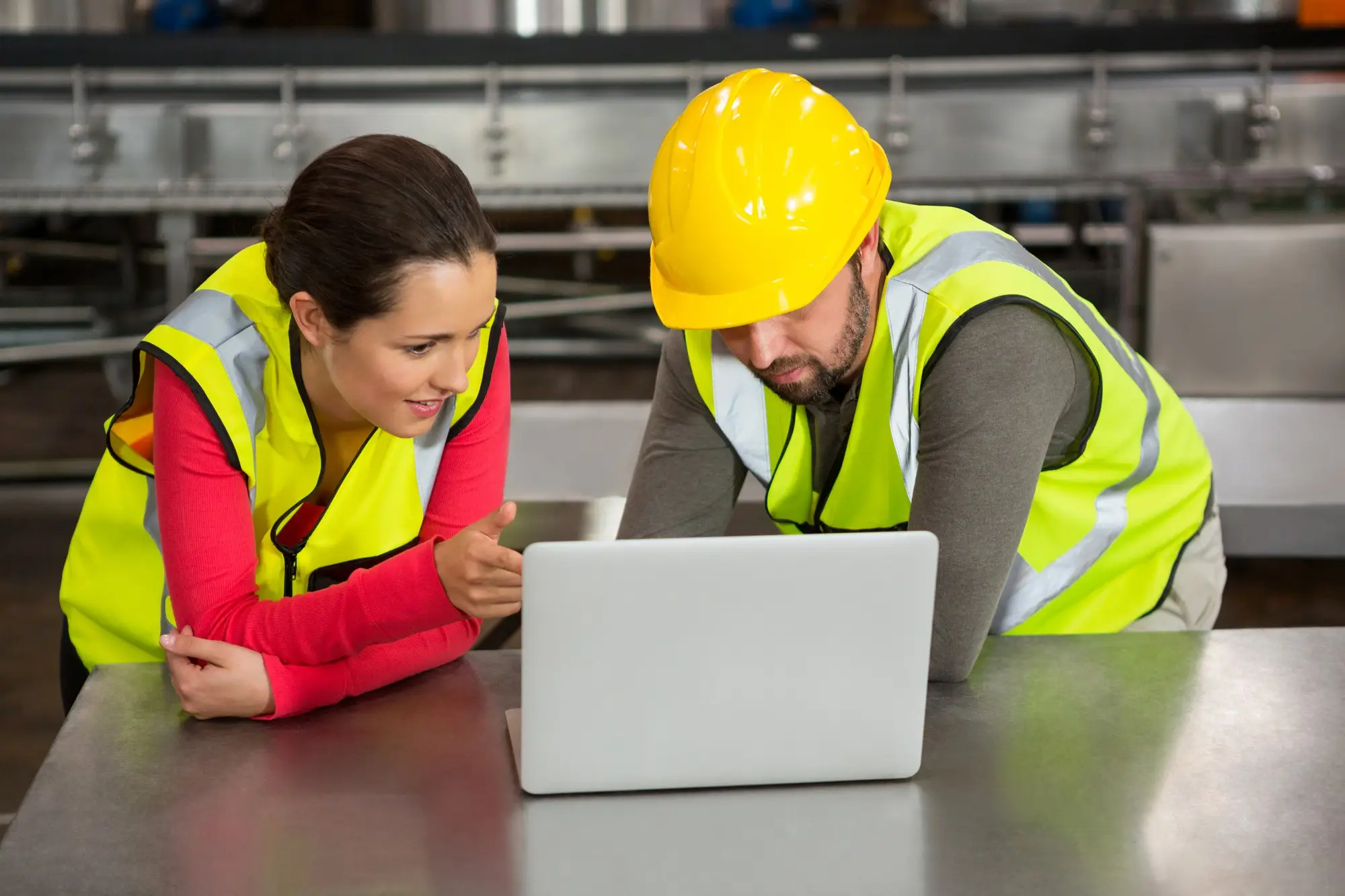 two workers, filling workplace safety audit together